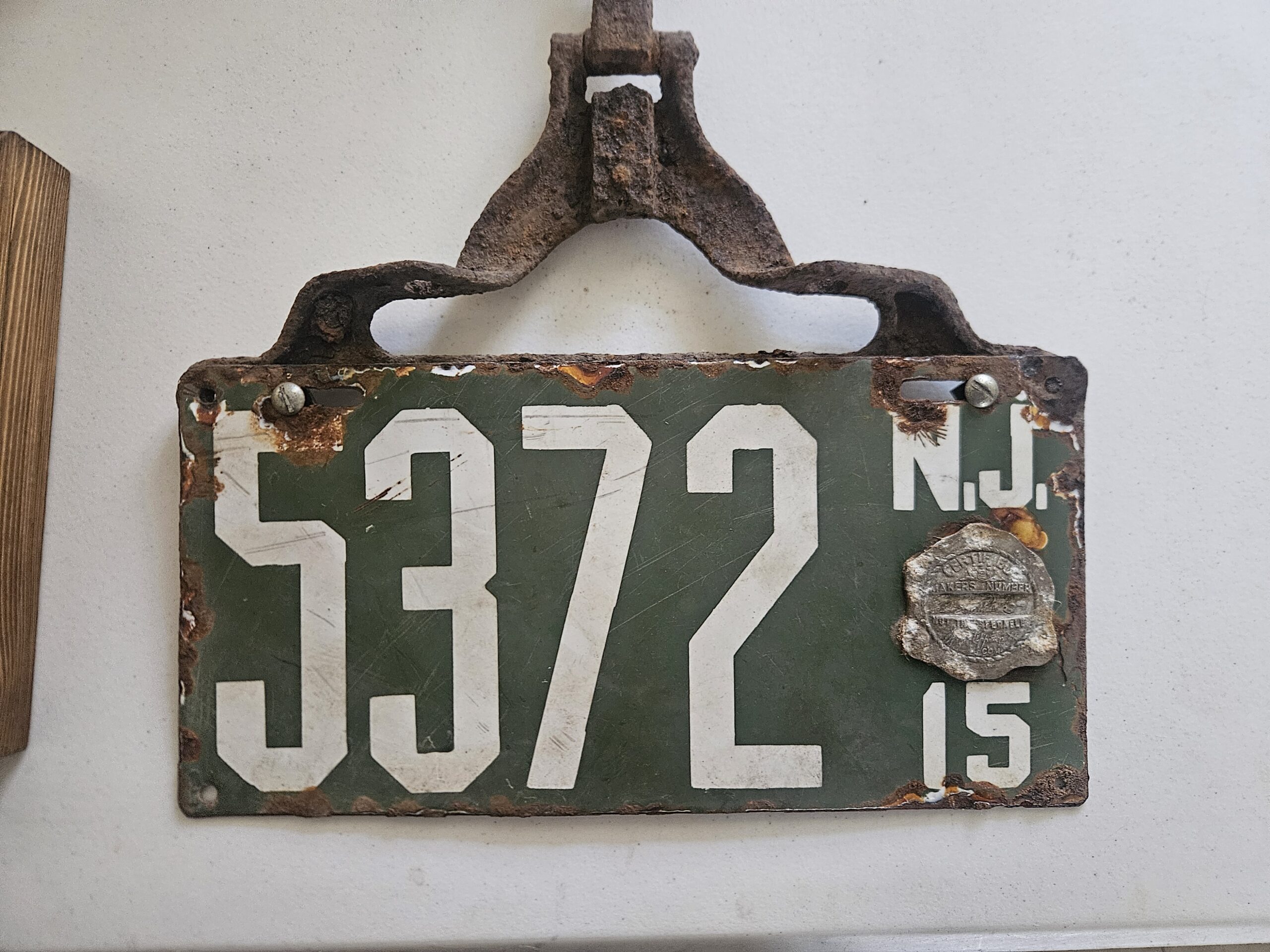 Weathered green 1915 New Jersey license plate numbered 5372